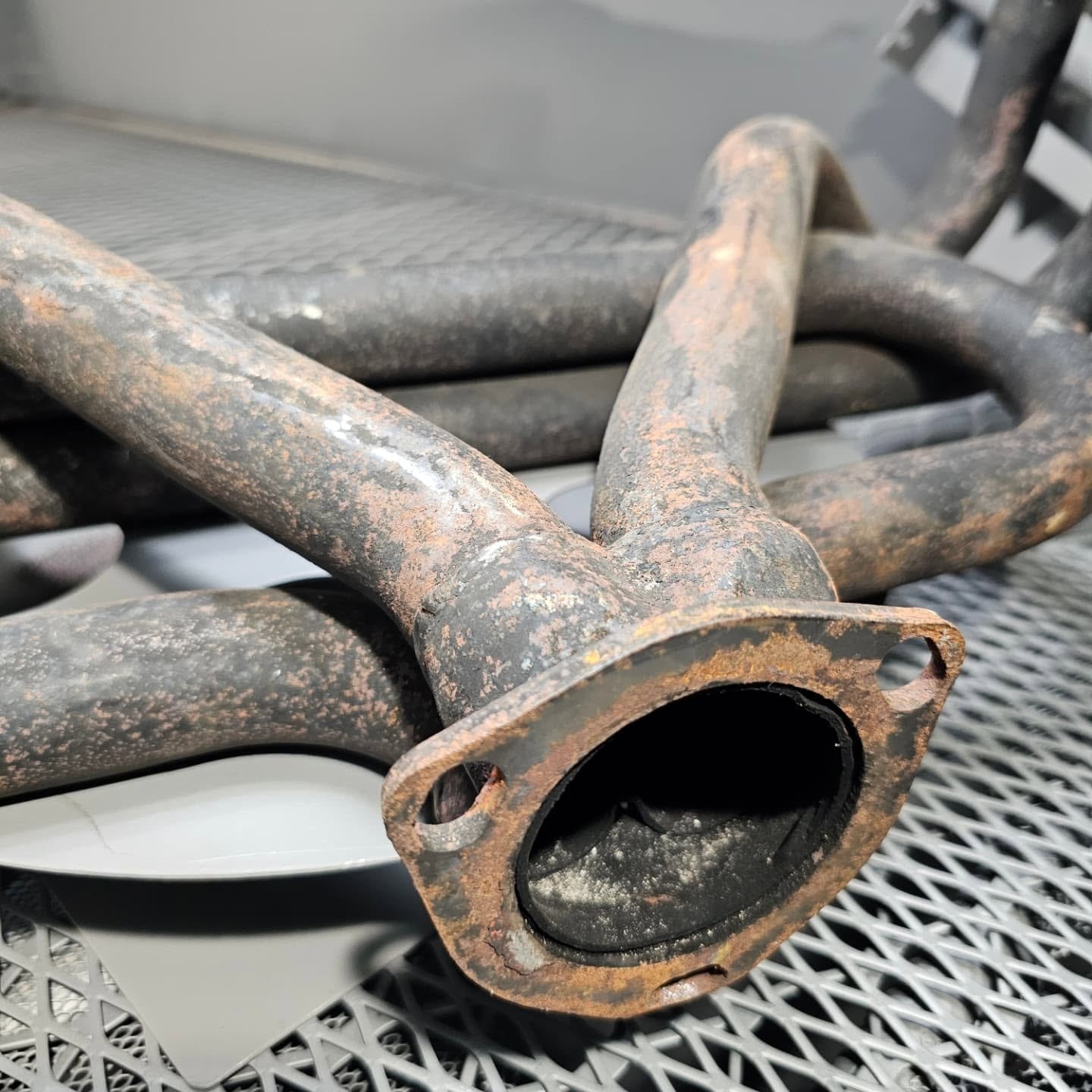 Rusty, heat-discolored exhaust headers before ceramic coating